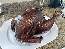 A whole smoked turkey cooked for Thanksgiving dinner