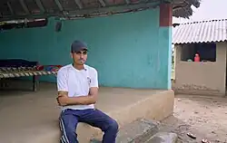 A young Van Gujjar man sitting on floor