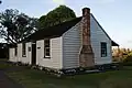 Acacia Cottage, exterior, showing the external brick chimney.