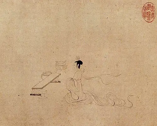 Woman seated in front of an empty table