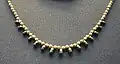 Necklace made of golden beads and pendants of jasper