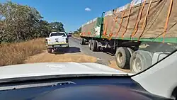 A damaged road surface in Africa showing deep potholes caused by pavement failure