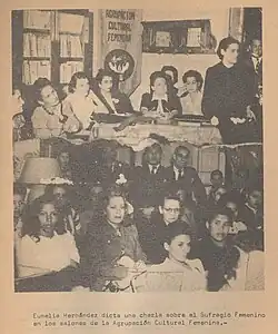Eumelia Hernandez gives a talk on Women's Suffrage in the halls of the Women's Cultural Association