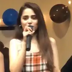 Photograph of girl singing on a mic