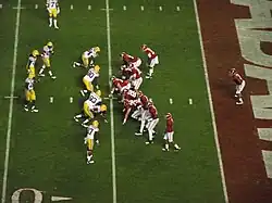 American football players prior to running a play.