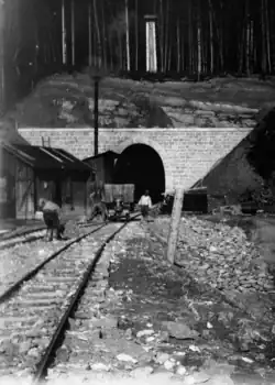 Photo of construction workers in front of a tunnel portal