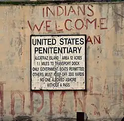 Prison sign on building and the Indian graffiti