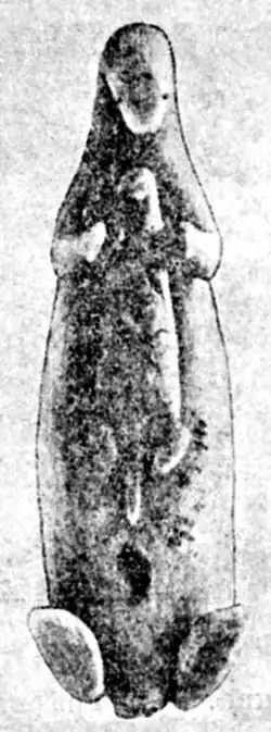 Image of Aleut carving of a sea otter hunt on a whalebone spear