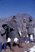 Alice Kandell hiding behind a Sikkimese soldier to take a photograph of a Chinese soldier along the Nathu La Pass, Sikkim