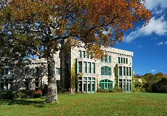 A large mansion in a rural parkland setting.