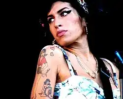 Image 128In 2008, Amy Winehouse tied the then record for the most wins by a female artist in a single night and became the first British woman to win five Grammys. (from 2000s in music)