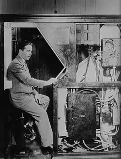 Anatol Josepho inside his photo booth in 1927