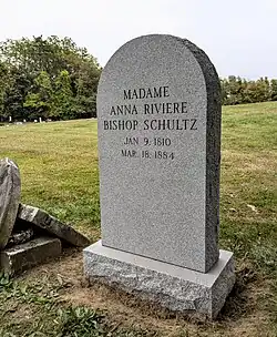 A granite gravestone with the text "MADAME ANNA RIVIERE BISHOP SCHULTZ, JAN. 9, 1810, MAR. 18, 1884