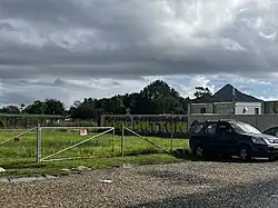 Graffiti reading "Dump Dutton" on a wall outdoors
