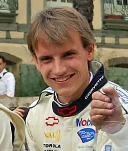 Marc Lieb wearing a white, red and black jacket and looking at the camera