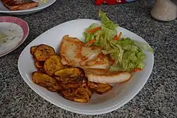 Fried bananas, served with lettuce, carrots and Arapaima.