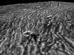 A simulated flyover view of Arbela Sulcus, showing how its grooved terrain snakes through and interrupts the rougher Nicholson Regio through resurfacing processes.[20]