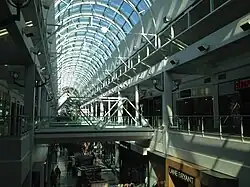 View of Arden Fair's skylight roof and interior storefronts taken from the second level