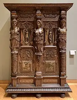 Henry II style wardrobe; c. 1580; walnut and oak, partially gilded and painted; height: 2.06 m, width: 1.50 m, depth: 0.60 m[123]