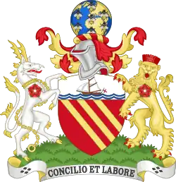A coat of arms with a lion and a unicorn holding a red shield with three yellow diagonal stripes. Beneath the words "CONCILIO ET LABORE" are written, and at the top there is a globe sitting on top of a knight's helmet.