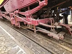 A brake shoe of the manual brake is visible to the right of the wheel.