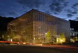 Art museum building at dusk, glowing from interior lighting