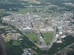Aerial photograph showing a large industrial area, including a number of laboratory buildings (some with chimneys), roadways, and recreational areas