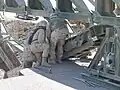 Soldiers (299 MRBC USAR [1]) attach the link reinforcement set to the underside of the bottom panel