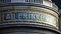 One of the Printemps Haussmann's frontage mosaics, reading 'Au Printemps' ('At the Printemps')