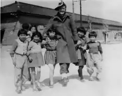 An Australian soldier, John Rose, with Japanese children in Hiroshima, 1947.