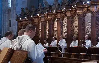 Choir of monks during the liturgy in the monastery church of the abbey Heiligenkreuz