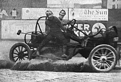 A malletman balances on the side of a moving auto polo car during a match in 1913.