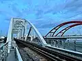 Bình Lợi Railway Bridge next to the same name bridge on Phạm Văn Đồng Boulevard crosses Saigon River in Ho Chi Minh City.