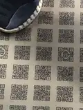 The unscannable QR codes, non-compliant with QR code standards, used as floor designs, sometimes featuring the DENCHA logo.