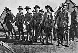 A group of standing men wearing World War I-era military uniforms