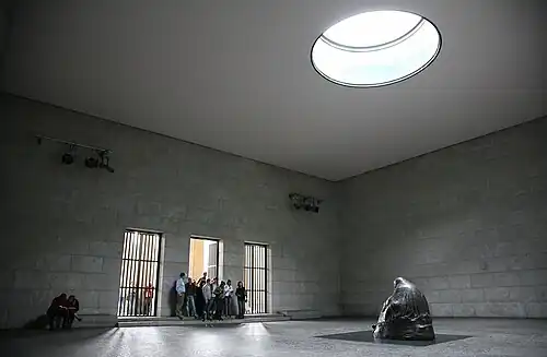 Image 19 Neue Wache Photo credit: Daniel Schwen The interior of the Neue Wache, the central memorial of Germany for victims of war and tyranny. Located in Berlin, the building was originally built as a guardhouse, and has been used as a war memorial since 1931. The statue, Mother with her Dead Son is directly under the oculus, and so is exposed to the rain, snow and cold, symbolising the suffering of civilians during World War II.