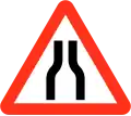 Road narrows on both sides