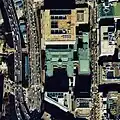 Aerial view (1984) with original building and eastern extension (green roofs), new building (top), and southern annex (bottom left)