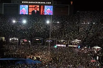 (C) The above-described four-teleprompter set-up in use at the 2008 Democratic National Convention in Denver, Colorado, USA (The large confidence monitor under the TV cameras is near the bottom far right of this frame.).
