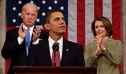 Photo of Obama giving a speech to Congress, with Pelosi and Biden clapping behind him