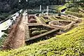 The rose garden is built on a slope and has a geometric structure.