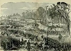 black-and-white depiction of 19th century United States soldiers charging a line of opposing troops which is in the edge of the woods; the opposing troops are flying the Confederate battle flag