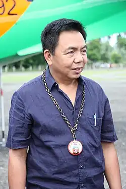 Fernando wearing a navy polo with a medal