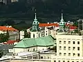 The copper roof and bell towers of the church as seen from the west