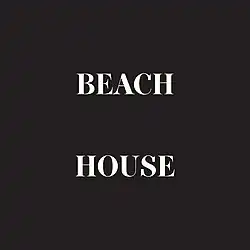 Above a black background, white bolded text depicted as "Beach House", with both words separated.