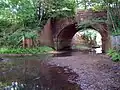 The river passes beneath the railway, north of Fulliford Passage