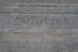 Detail of an engraved stone with a difficult-to-interpret inscription