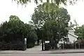 Exeter elm (background), De Iepenhof [: elmcourt] cemetery, Hoofddorp, Netherlands (2016)[16]
