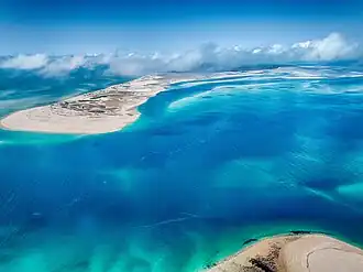 Aerial photograph of Benguerra Island in Mozambique showing turquoise water, sandbanks, and white beaches.