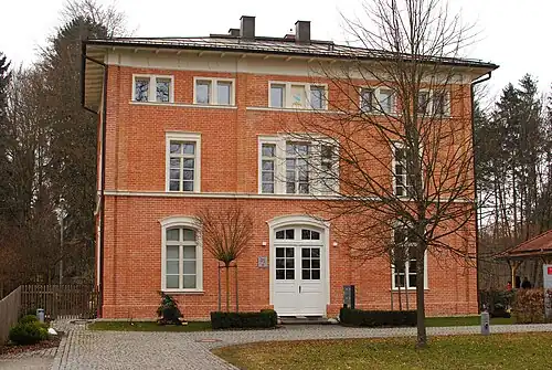 Three-story brick building with hipped roof